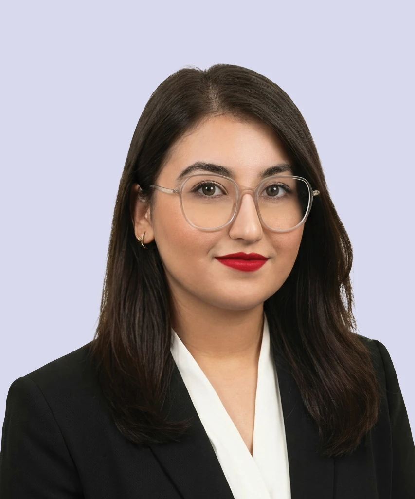 Professional portrait of Eisha Arif, HR & Admin Manager at VisionTact, wearing glasses and business attire.