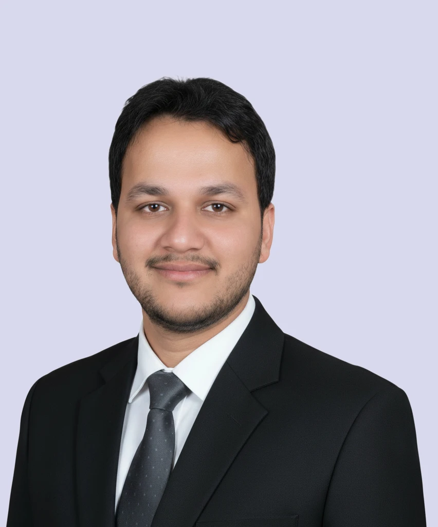Professional portrait of Adnan Ahmed, Operations Manager at VisionTact, in a black suit.