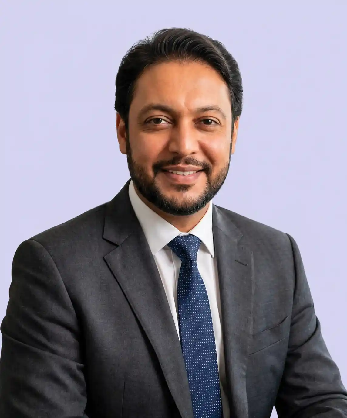 Professional portrait of the VisionTact founder wearing a navy suit in an office setting.